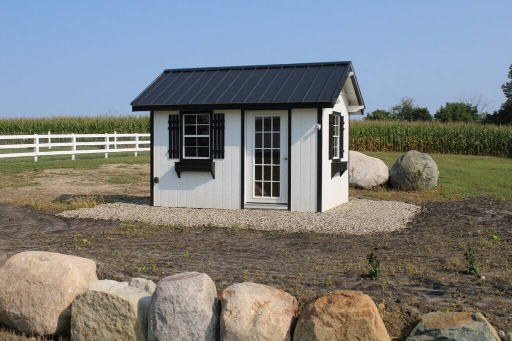 Small outdoor shed in front of field