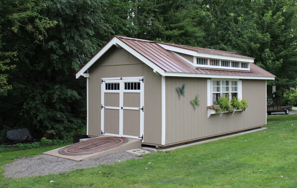 Tan utility shed in backyard