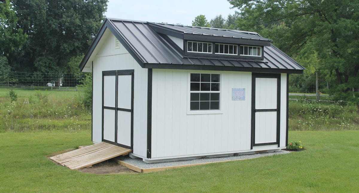 White utility shed in backyard