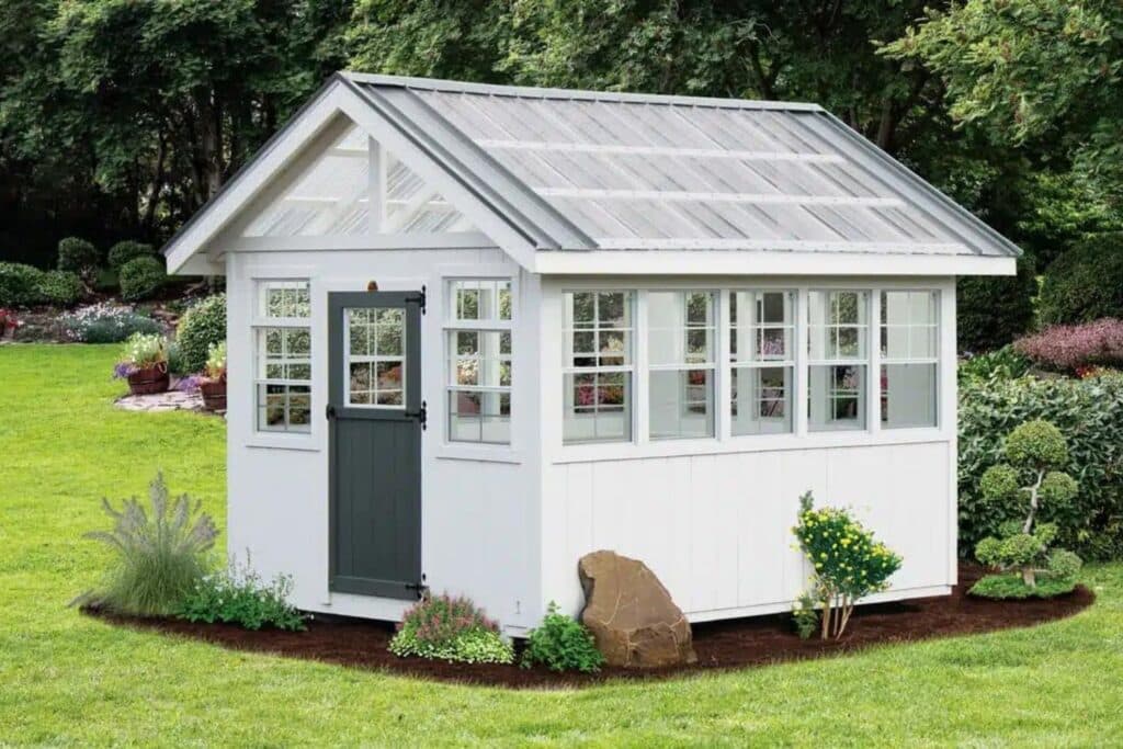 White Green House Shed in Indiana Backyard with green door