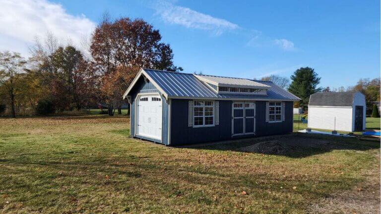 Blue garage shed in backyard by shed
