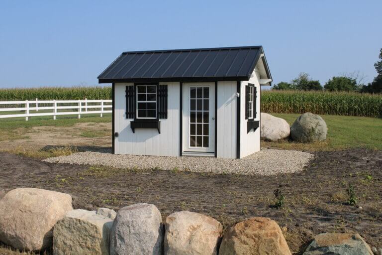 Small outdoor shed in front of field