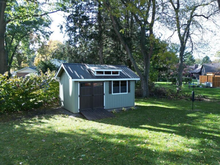 Green mini barn in backyard