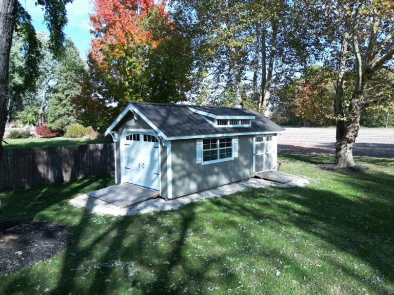 Green gable garage in backyard