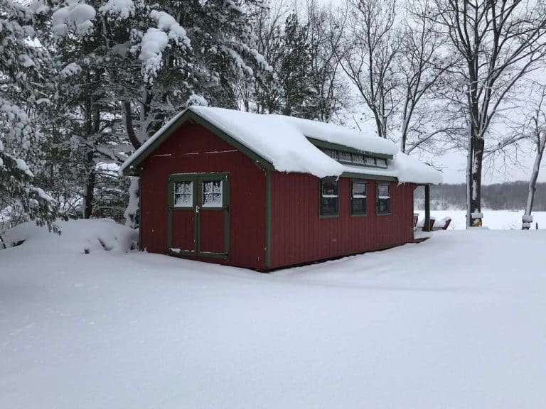 Snow covered cabin in backyard
