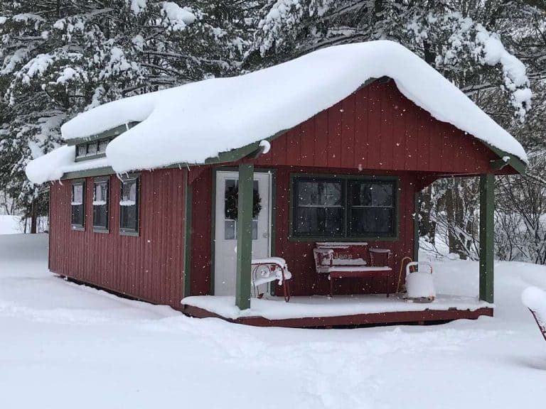 Shed covered in snow in backyard